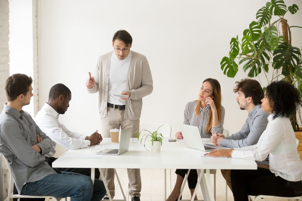 caucasian team leader rebuking african employee mistake meeting (1) caucasian team leader rebuking african employee mistake meeting (1)